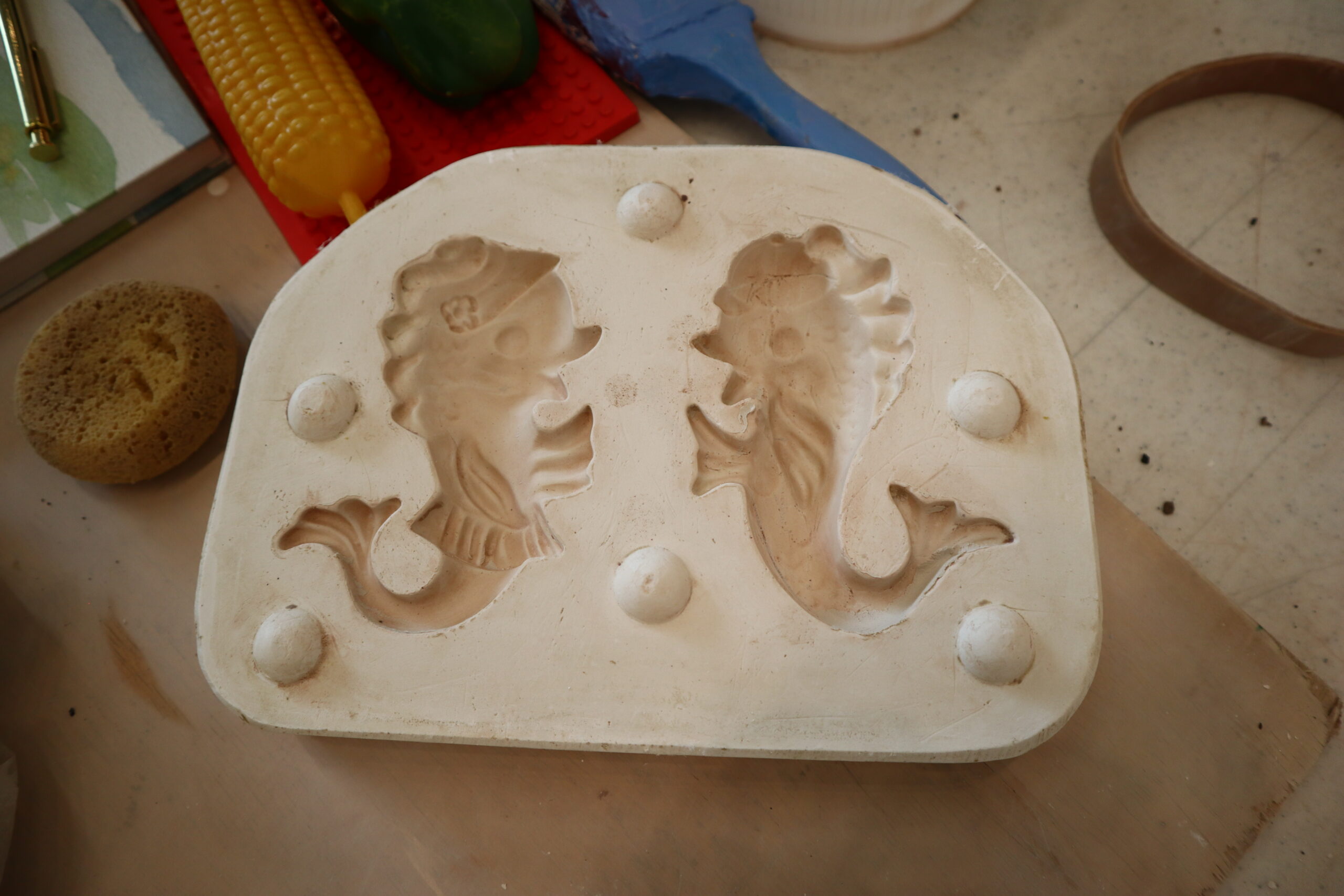 White silicone baking mold with two angel-shaped cavities on a kitchen counter.
